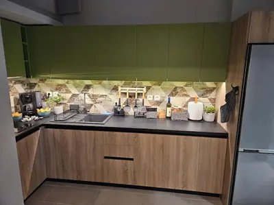 a kitchen with green walls and a counter top at Ellis Apartment in Athens