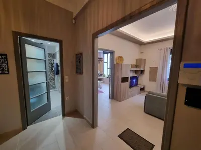 a hallway with a door open to a living room at Ellis Apartment in Athens