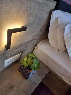 a bedroom with a bed and a potted plant on the floor at Ellis Apartment in Athens