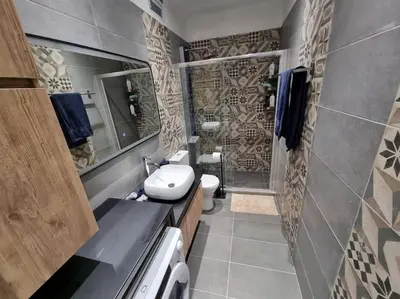 a bathroom with a sink and a toilet in it at Ellis Apartment in Athens
