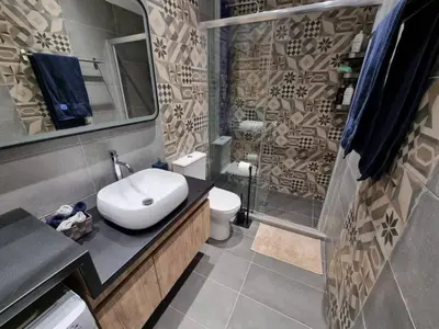 a bathroom with a sink and a toilet and a shower at Ellis Apartment in Athens