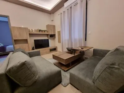a living room with a couch and a table at Ellis Apartment in Athens