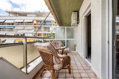 a balcony with a chair and a table at Live like an Athenian! in Athens