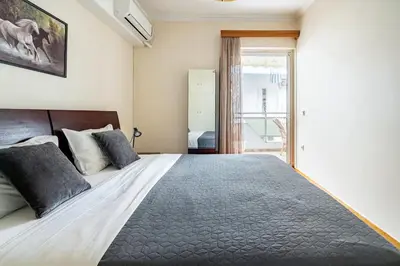 a bedroom with a large bed and a window at Live like an Athenian! in Athens