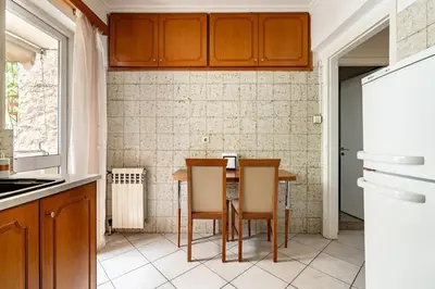 a kitchen with a table and two chairs at Live like an Athenian! in Athens