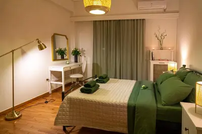 a bedroom with a green bed and a desk at Green Oasis in the center of Athens in Athens