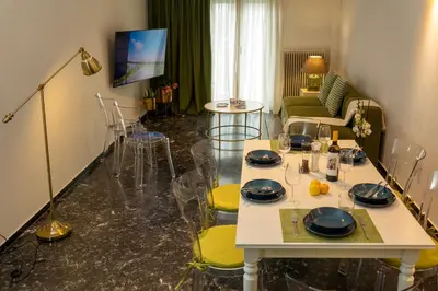 a living room with a white table and chairs at Green Oasis in the center of Athens in Athens