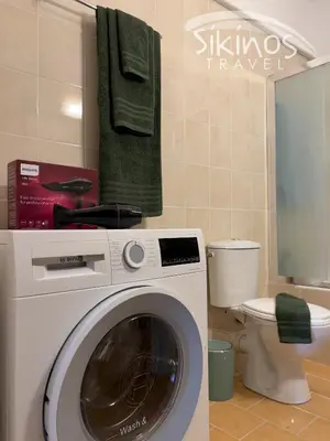 a washing machine in a bathroom with a toilet at Green Oasis in the center of Athens in Athens