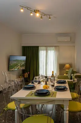 a dining room with a large white table and chairs at Green Oasis in the center of Athens in Athens