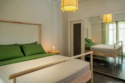 a bedroom with two beds with green sheets at Green Oasis in the center of Athens in Athens