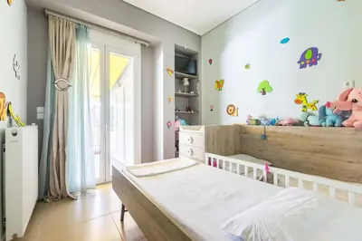 a childs bedroom with a bed and a window at Best Family House,Acropolis view,5 min from metro in Athens