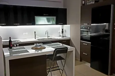 a kitchen with a counter with a sink and a stove at Best Family House,Acropolis view,5 min from metro in Athens