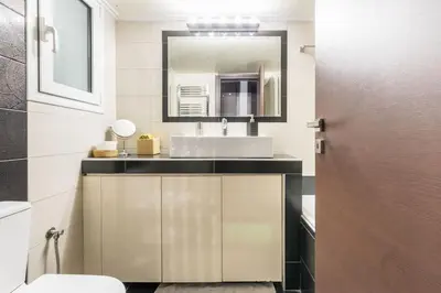 a bathroom with a sink and a mirror at Best Family House,Acropolis view,5 min from metro in Athens