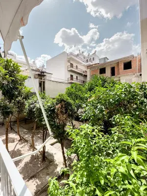 a view from a balcony of trees and buildings at Metro Chic Haven: Modernized Urban Studio near the Tram in Athens
