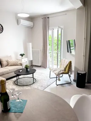 a living room with a couch and a table at Metro Chic Haven: Modernized Urban Studio near the Tram in Athens