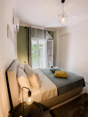 a bedroom with a large bed in front of a window at Metro Chic Haven: Modernized Urban Studio near the Tram in Athens