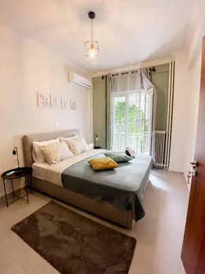 a bedroom with a bed and a large window at Metro Chic Haven: Modernized Urban Studio near the Tram in Athens