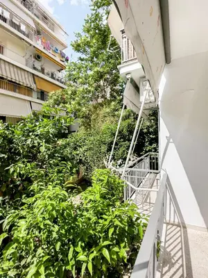 a staircase leading up to a building with plants at Metro Chic Haven: Modernized Urban Studio near the Tram in Athens
