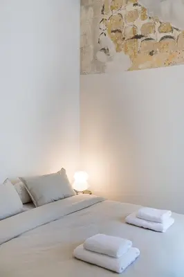 a bedroom with a bed with two towels on it at Charlie in Athens
