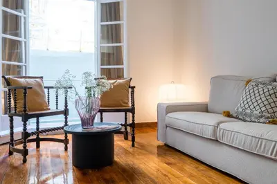 a living room with a couch and a table and chairs at Charlie in Athens