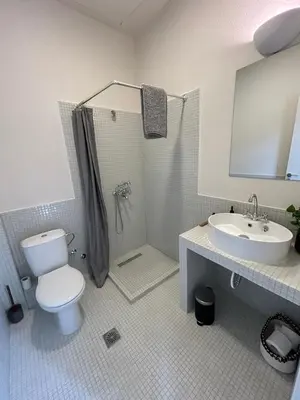 a bathroom with a toilet and a shower and a sink at Charlie in Athens