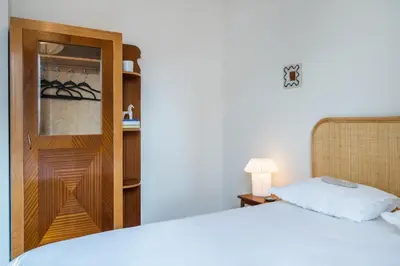 a bedroom with a bed and a cupboard with a white bed at Jade in Athens
