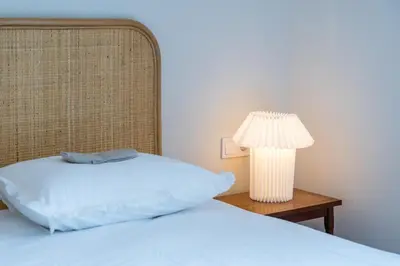 a bedroom with a bed and a lamp on a table at Jade in Athens