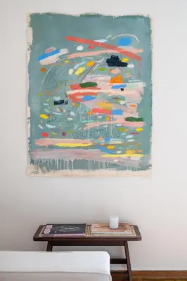 a painting hanging on a wall next to a coffee table at Jade in Athens