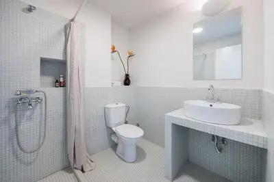 a bathroom with a toilet and a sink and a shower at Jade in Athens
