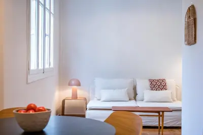 a living room with a white couch and a table at Crane in Athens