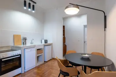 a kitchen with a table and chairs in a room at Crane in Athens