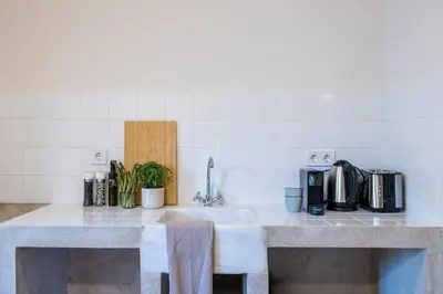 a kitchen counter with a sink and some appliances at Crane in Athens