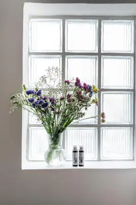 a vase of flowers sitting on a window sill at Crane in Athens