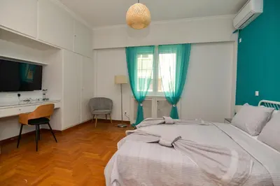 a bedroom with a bed and a desk and a television at Athens central studio in front of Syntagma metro in Athens