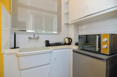 a small kitchen with a sink and a microwave at Athens central studio in front of Syntagma metro in Athens