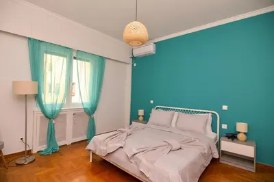 a blue bedroom with a bed and a blue wall at Athens central studio in front of Syntagma metro in Athens