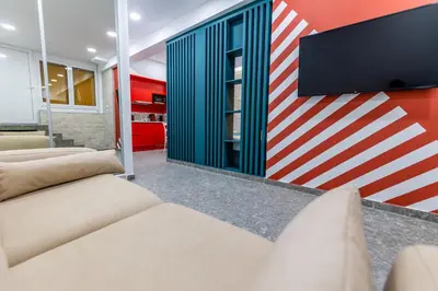 a living room with two couches and a tv on a wall at Bright Apartment In The Center VIPGreece in Athens