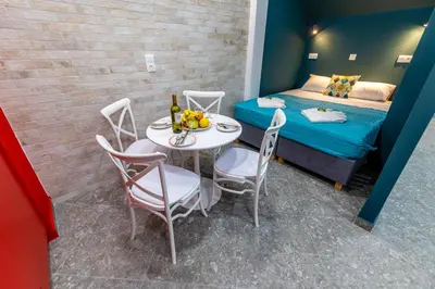 a small room with a table and chairs and a bed at Bright Apartment In The Center VIPGreece in Athens