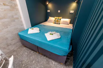 a small bedroom with a bed with towels on it at Bright Apartment In The Center VIPGreece in Athens