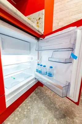 an open refrigerator with bottles of water in it at Bright Apartment In The Center VIPGreece in Athens