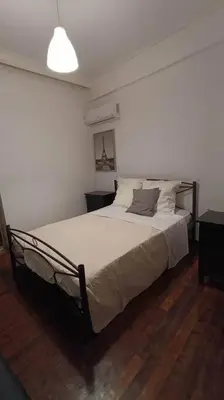a bedroom with a large bed in a room at Apartment by the Sepolia metro in Athens