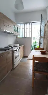 a kitchen with a stove and a table in it at Apartment by the Sepolia metro in Athens