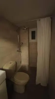 a bathroom with a toilet and a shower curtain at Apartment by the Sepolia metro in Athens