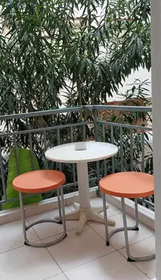 a table and two chairs sitting next to a table at Apartment by the Sepolia metro in Athens