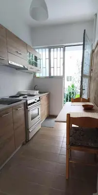 a kitchen with a stove and a table in it at Apartment by the Sepolia metro in Athens