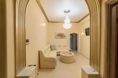 a living room with a couch and a chandelier at Penthouse Oasis in Athens