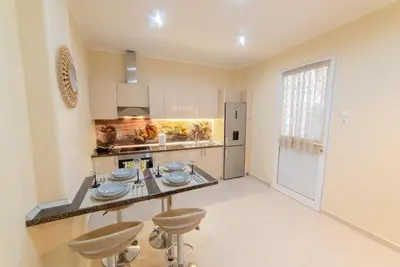 a kitchen with a table and two stools in it at Penthouse Oasis in Athens