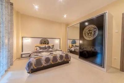 a bedroom with a large bed and a large mirror at Penthouse Oasis in Athens
