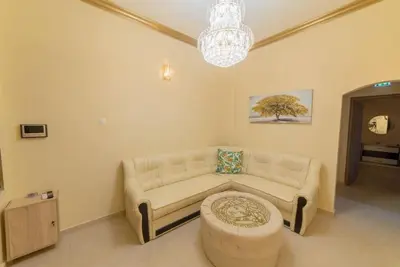 a living room with a couch and a table at Penthouse Oasis in Athens