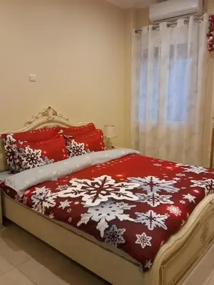 a bed with a red and white blanket and a window at Penthouse Oasis in Athens